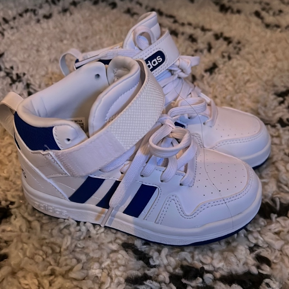White and blue adidas size 11 little kid high tops. Worn twice maybe. Like new